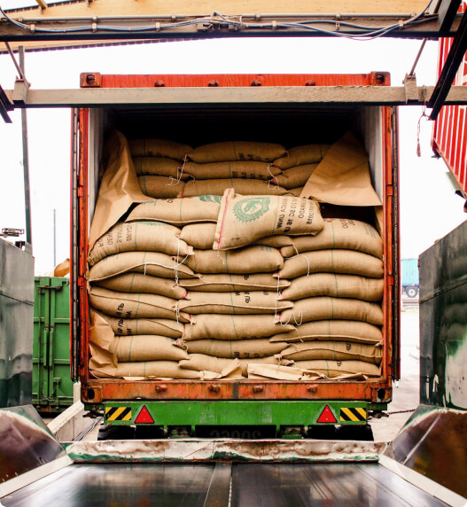 A truck unloads a load of coffee